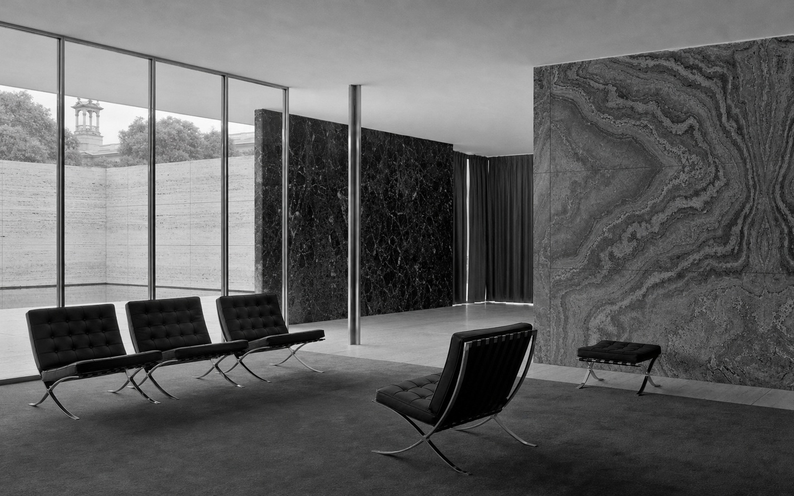 Black leather seating in a marble-and-glass pavilion. AI-generated image for illustration purposes.