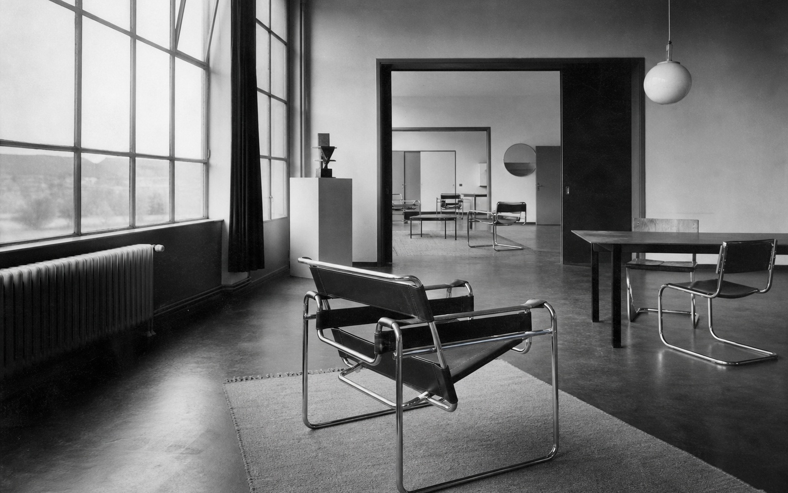 Tubular-steel seating in a window-lit modernist interior. AI-generated image for illustration purposes.