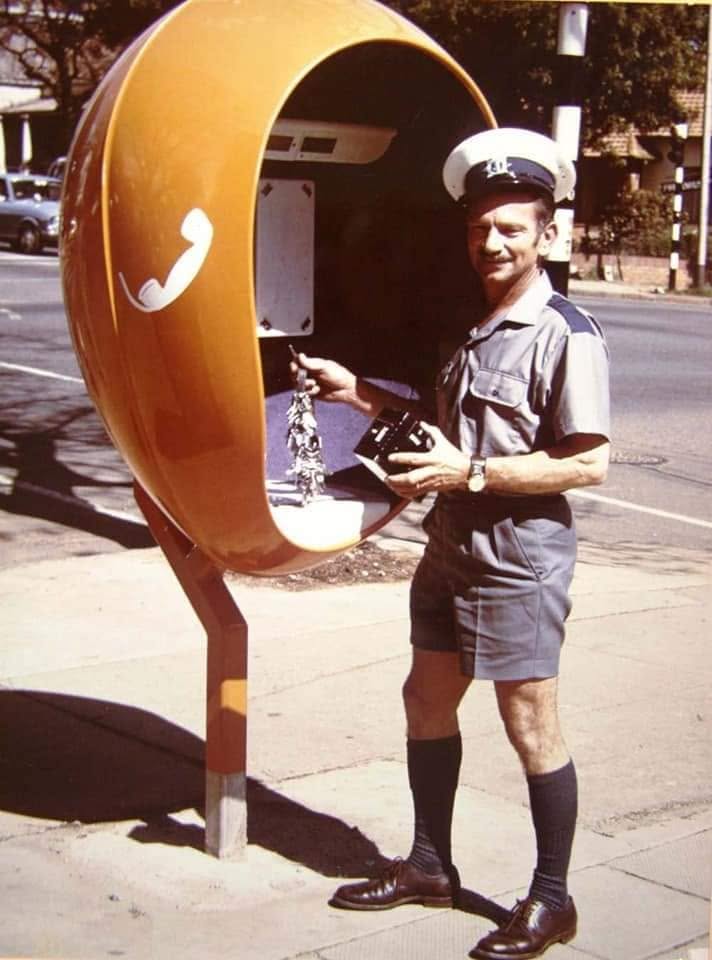 Orange egg-shaped roadside telephone booth