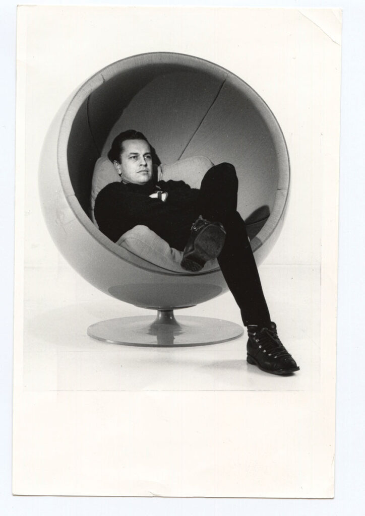 Eero Aarnio reclining in his own Ball Chair, 1960s